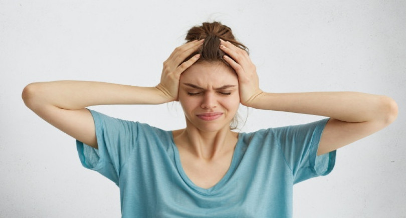 worried-woman-closing-her-eyes-with-hands-head-having-headache_273609-7592